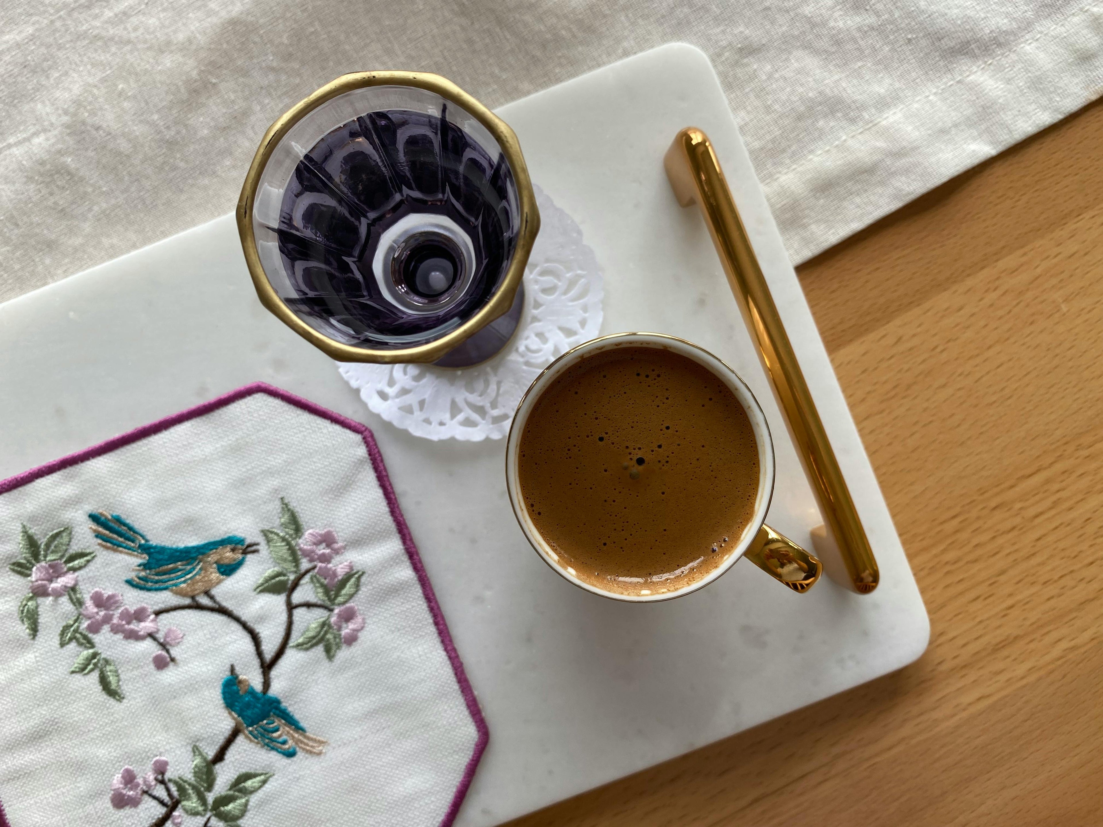 Close-up of luxury marble tray with brass handle, styled with tea and coffee, handcrafted premium decor accessories in Dubai by The Meem Store.