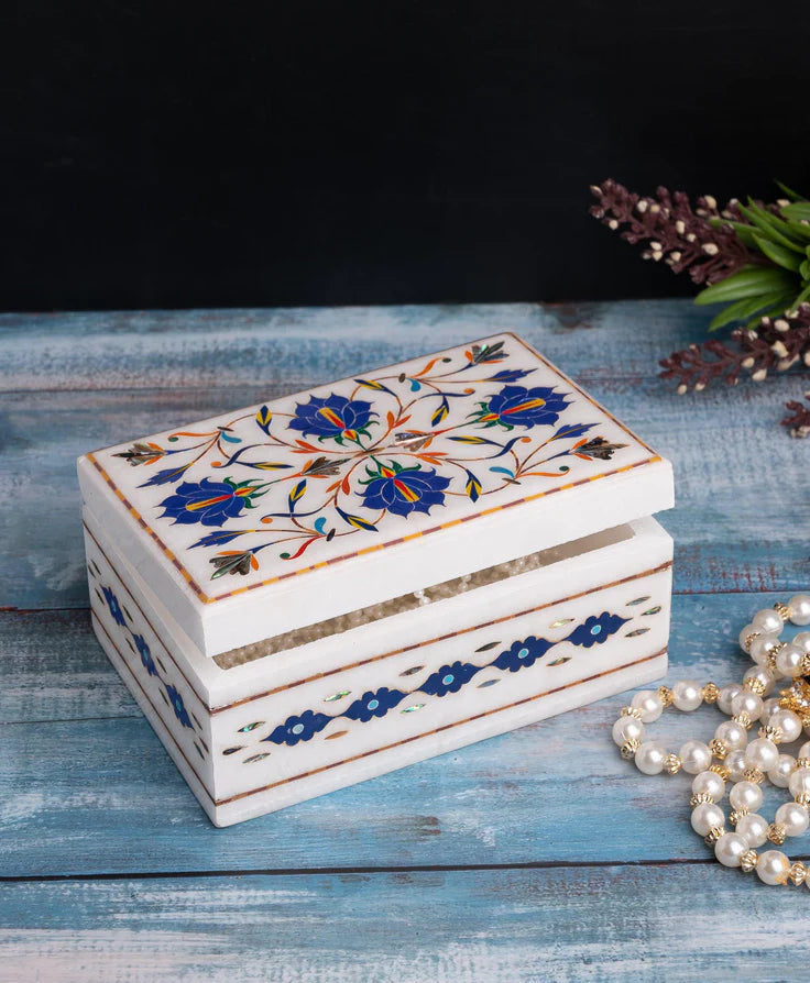 Decorative jewelry box with floral patterns on a wooden surface
