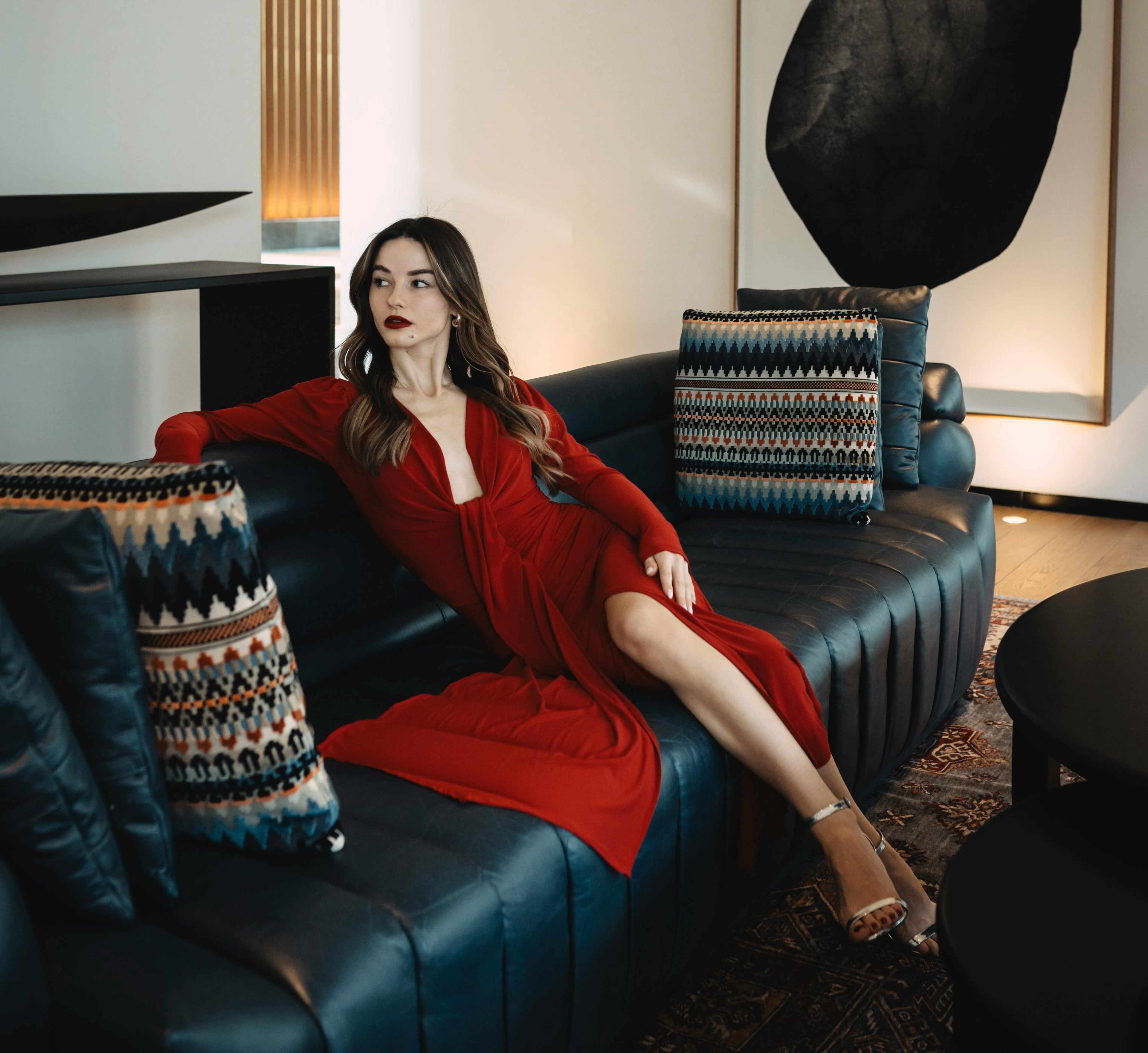 Model seated on a luxury sofa in Dubai with customization request option, premium handcrafted furniture by The Meem Store