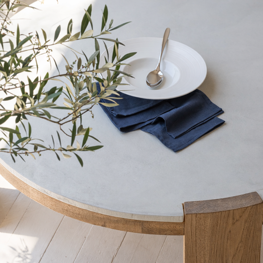 Close-up of oak wood leg and ivory stone top luxury center table