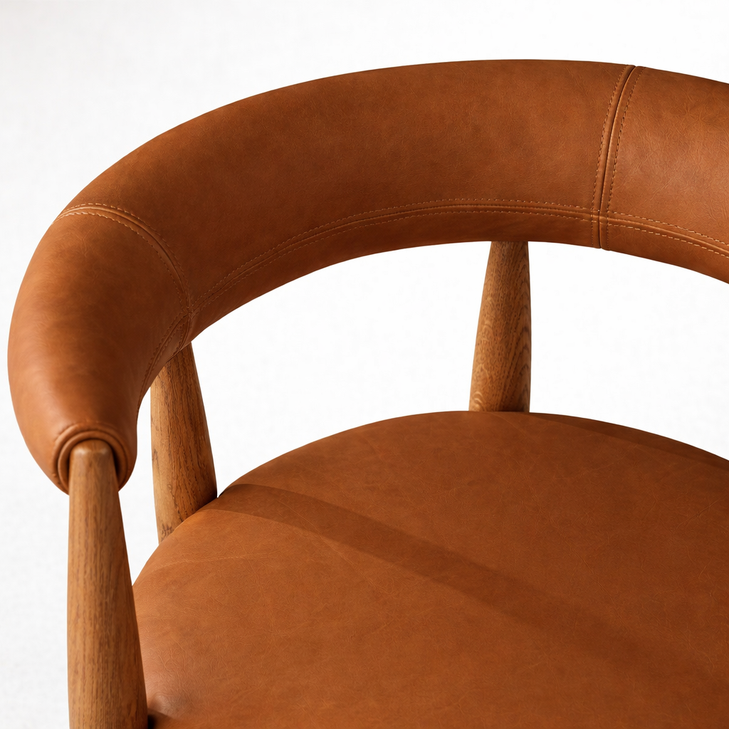 Close up of tan leather curved backrest and wood leg detail luxury dining chair UAE