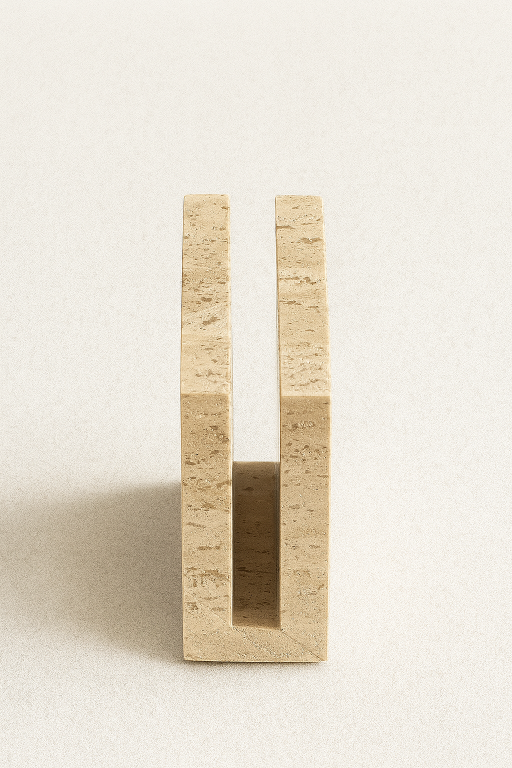 Side profile of beige travertine tissue holder with smooth handcrafted finish – The Meem Store